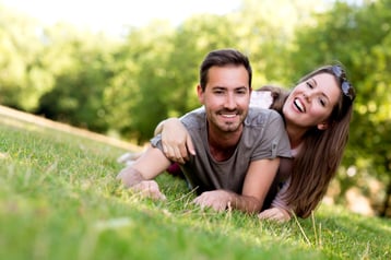 Couple outdoors enjoying a summery day looking happy